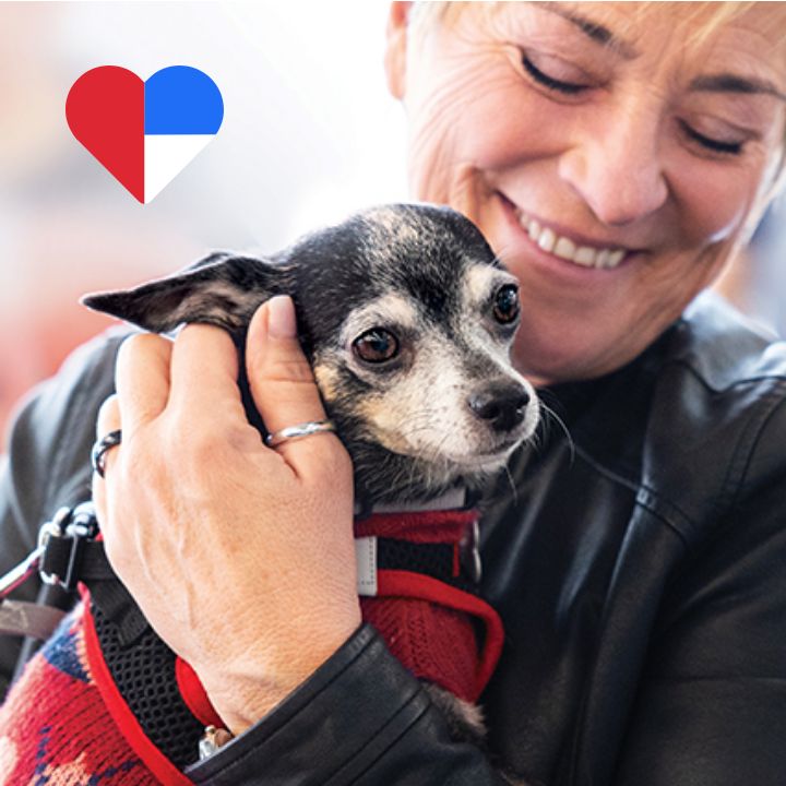 woman holding dog with petsmart charities logo
